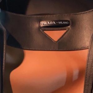 Large Prada bag with large wallet included. Have registration and duffel bag too